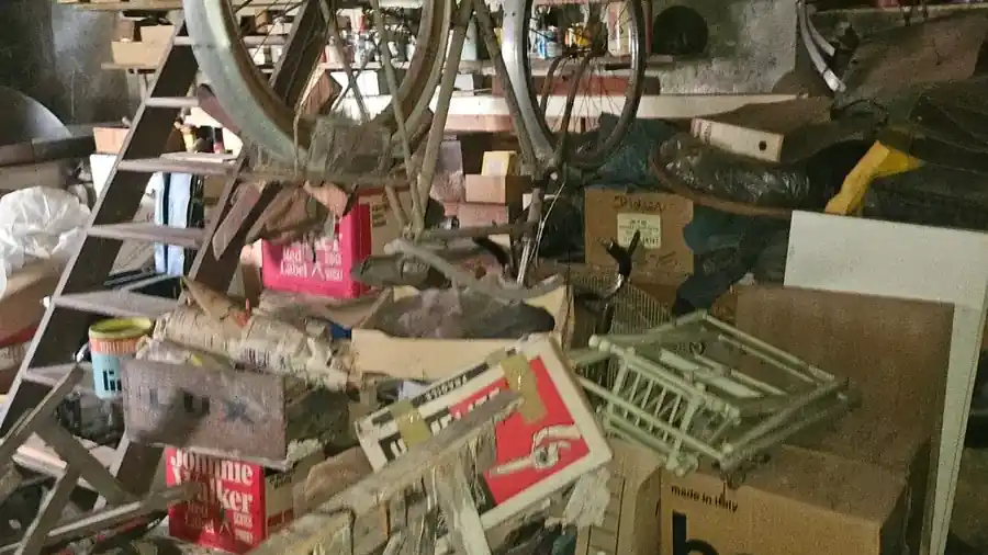 Grenier saturé de cartons et de mobilier avant un vide-maison complet