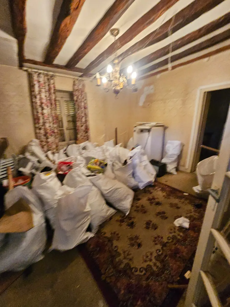 Salon d’une maison ancienne rempli de big-bags pendant un débarras